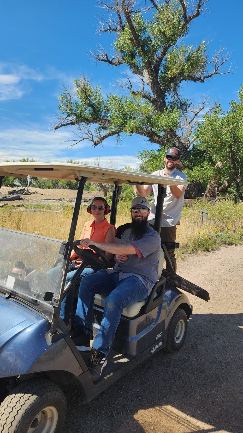 2 people in a golf cart